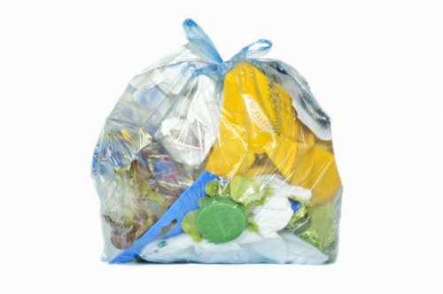 Fleet vehicle collecting commercial waste on a village street in Great Bookham